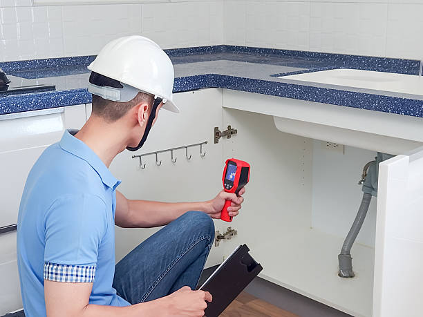 India Waterproofing Consultancy technician inspecting a wall with a leak detection machine